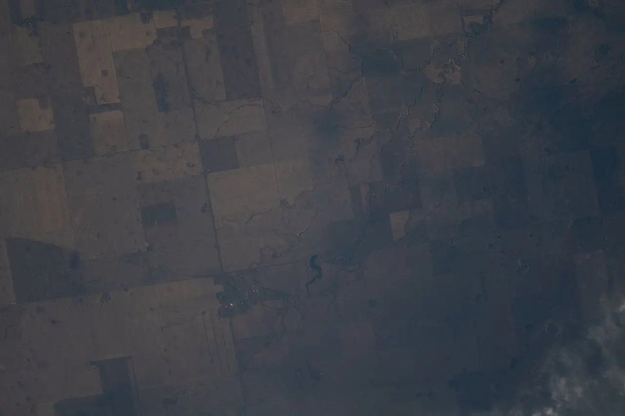 Aerial view of farmland and Peebles from space, 2021